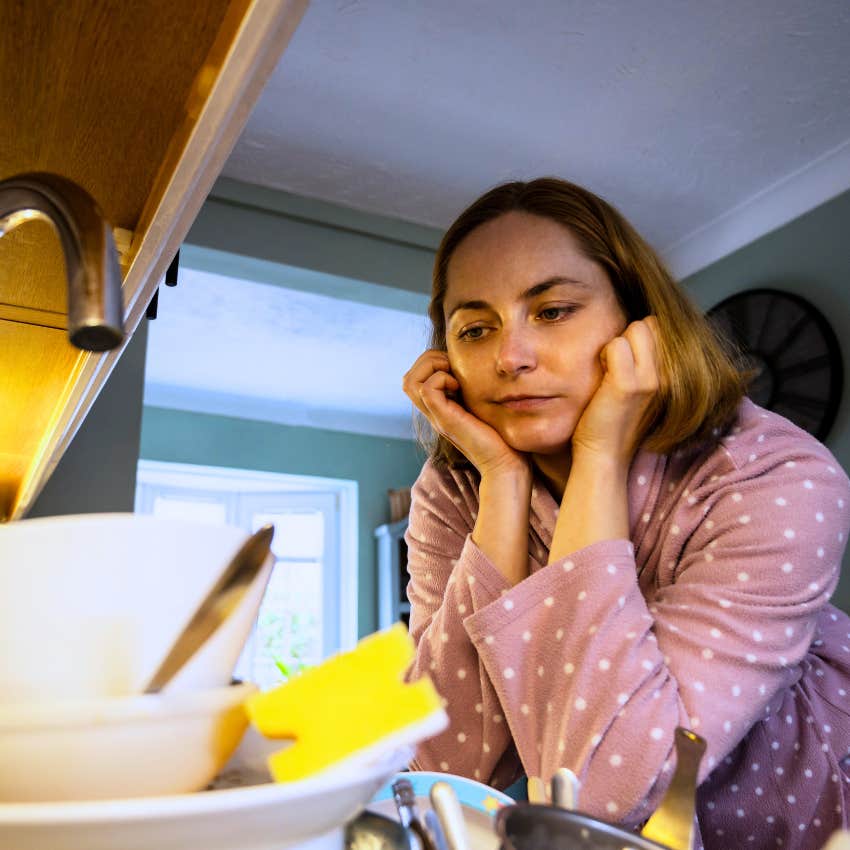 Messy woman saying "I'll get to it another time" at home.
