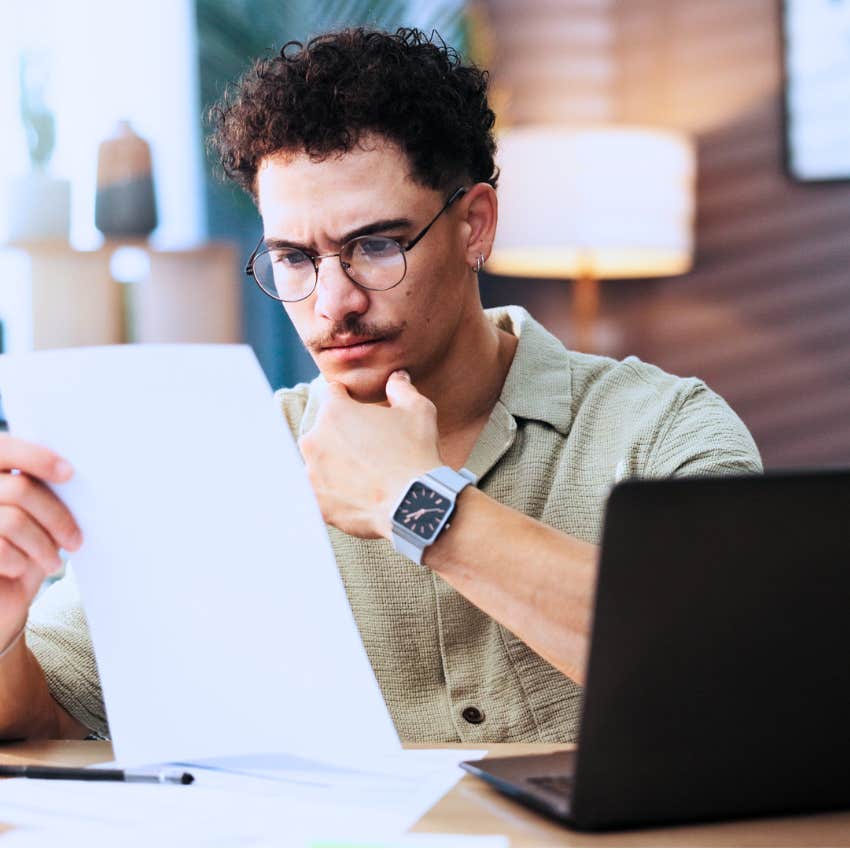 man looking at bill taking action to figure it out