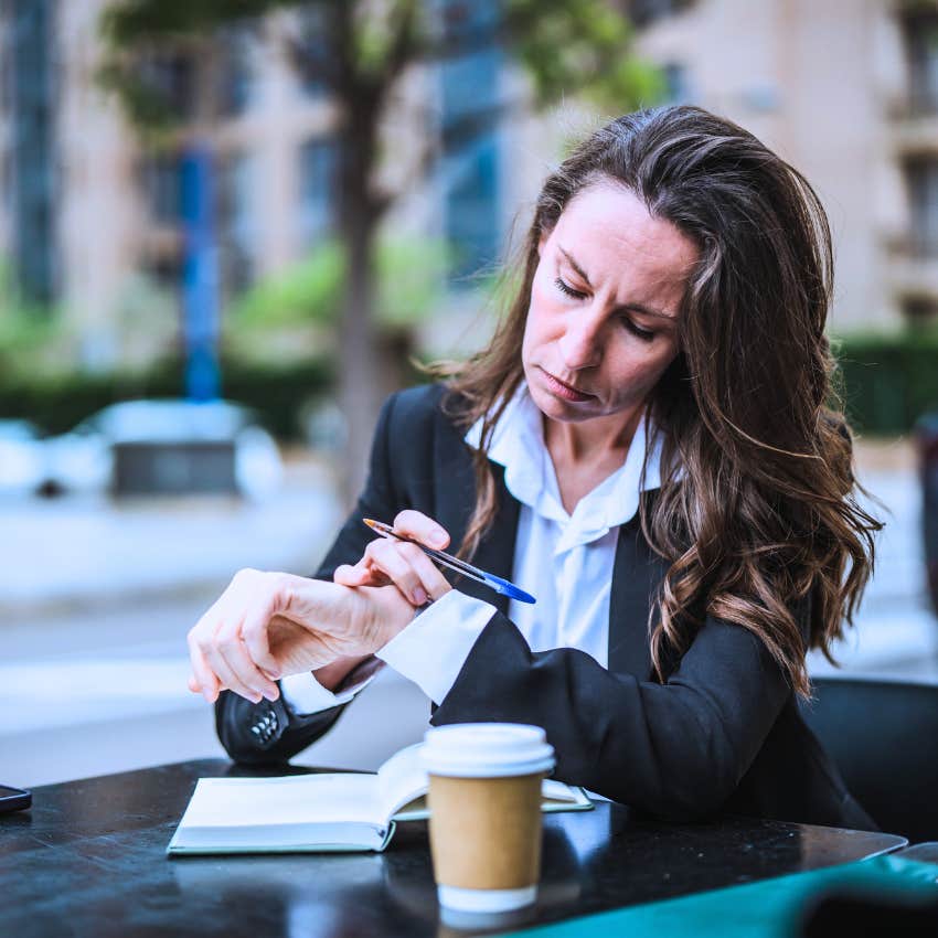 woman needing to stay busy looking at her watch