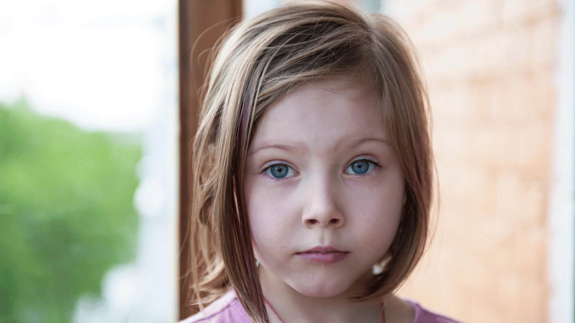 young girl being told stop crying or i'll give you something to cry about