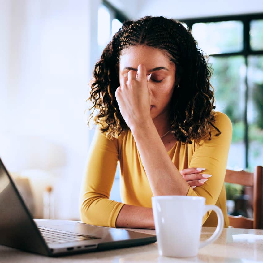 Woman self-abandoning at home over her computer.