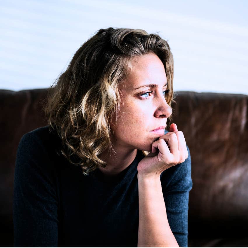 Woman suppressing and running from hard feelings at home.