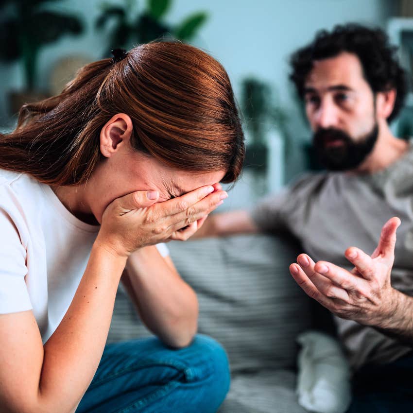 woman taking the blame with her miserable partner at home