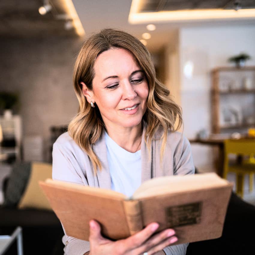 Gen X woman reading a book knowing that boredom isn't a bad thing
