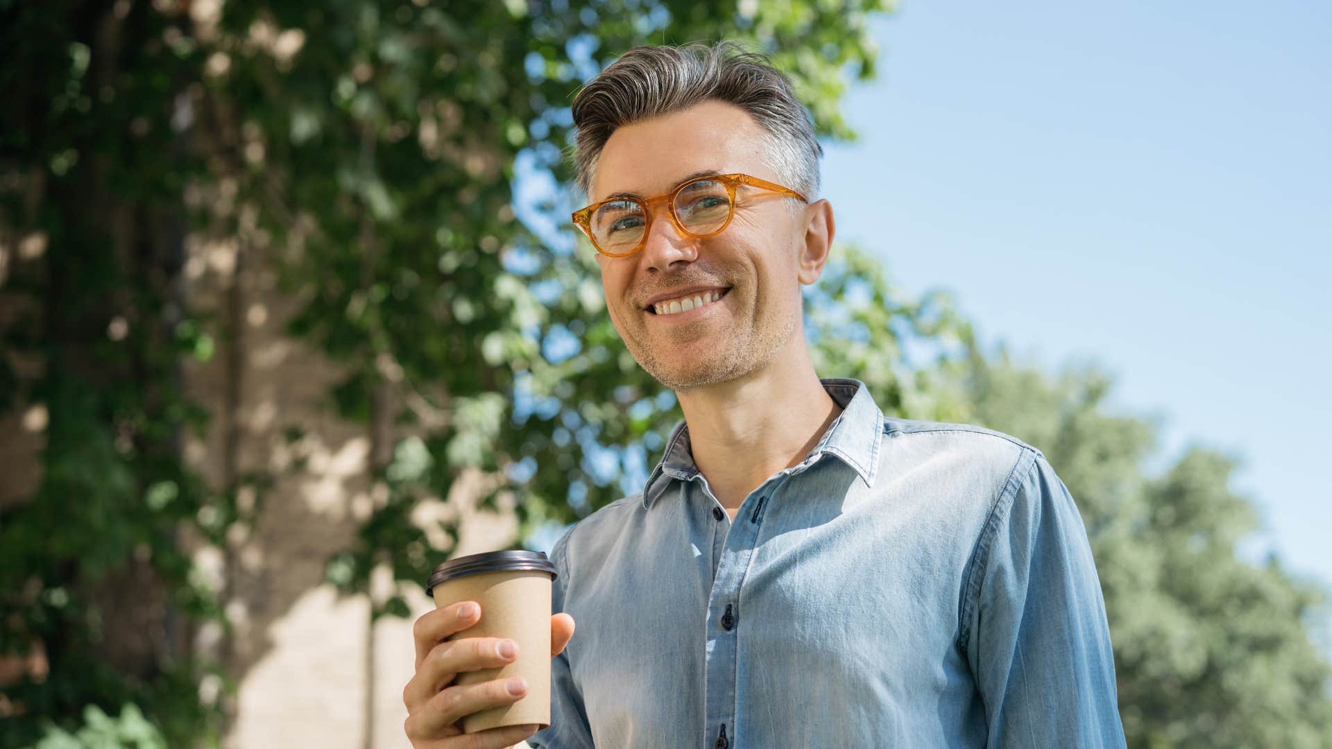 gen x man happily in bed by 10 enjoys a coffee early in the morning