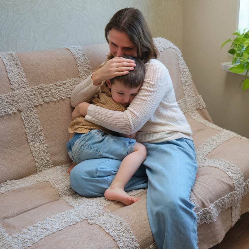 thoughtful mom comforting her sad little boy
