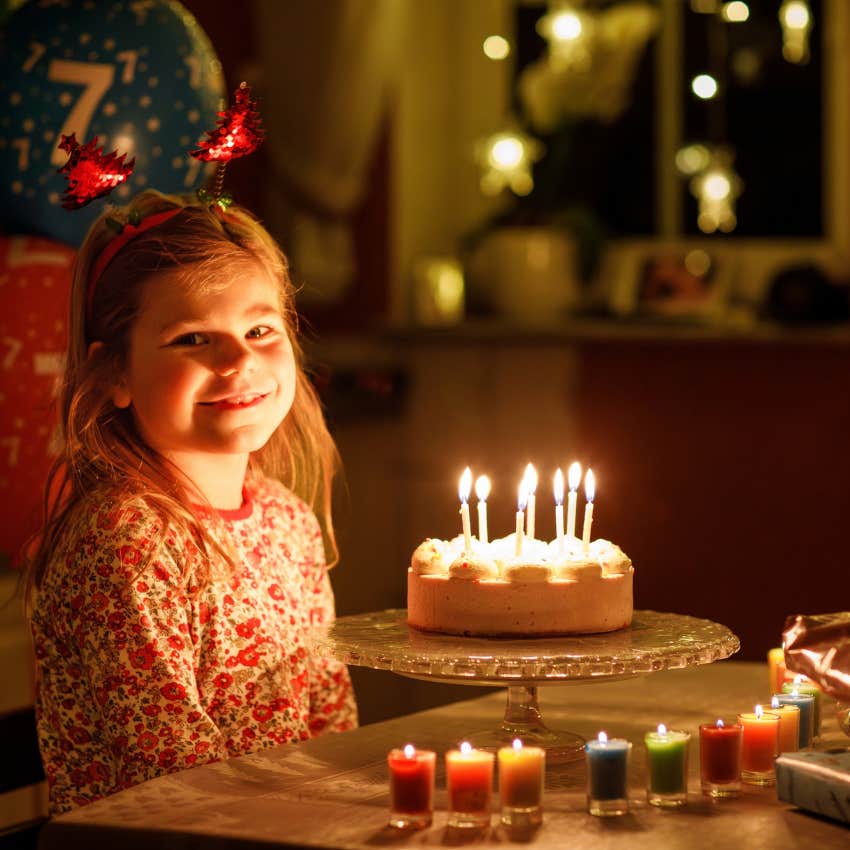little girl with thoughtful parents enjoying her special birthday tradition 