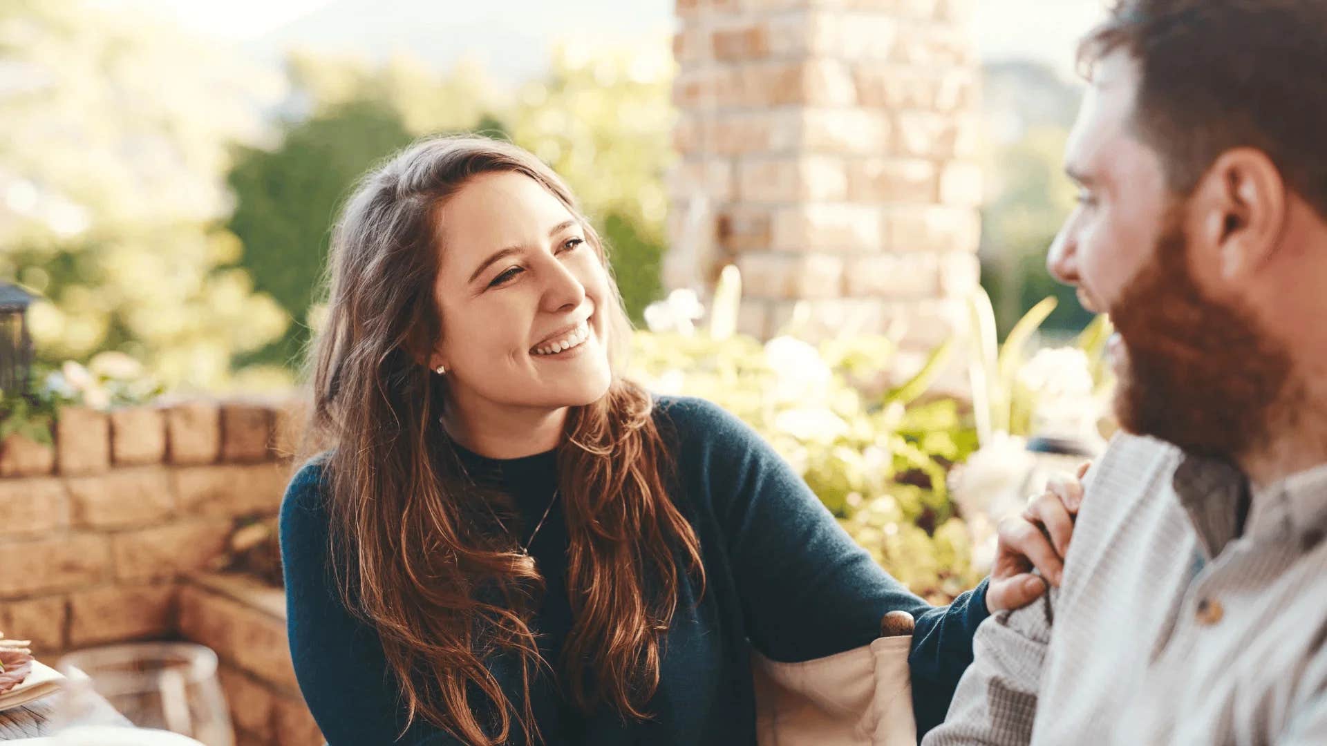 smiling woman being told nobody makes me happier than you
