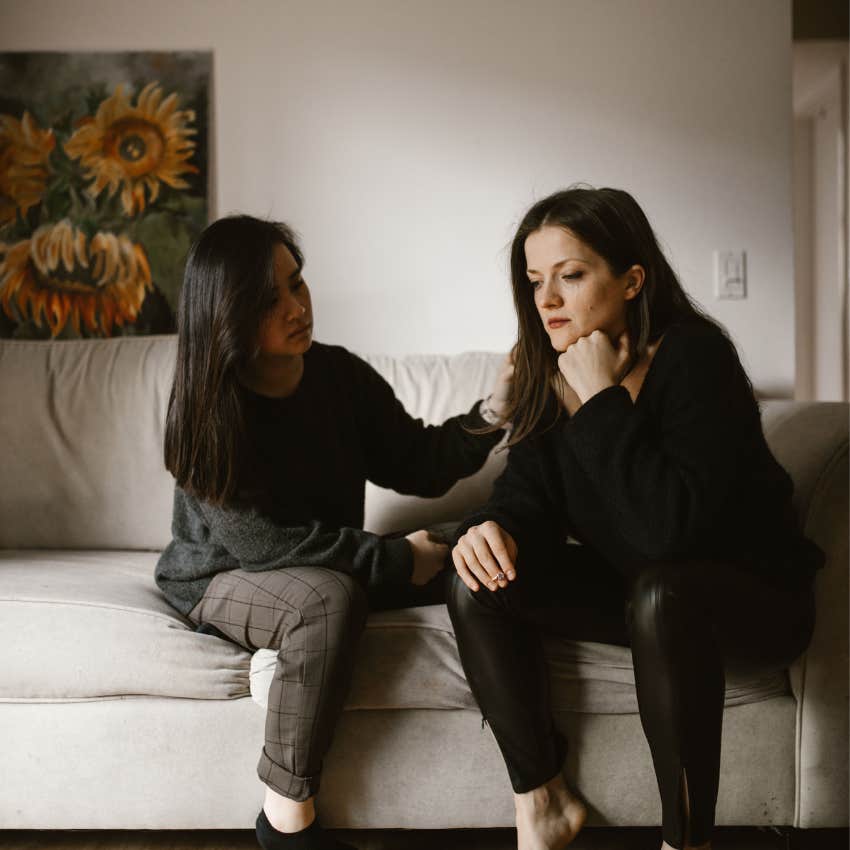Friend reassuring an upset woman during a conversation while encouraging her not to take the situation personally