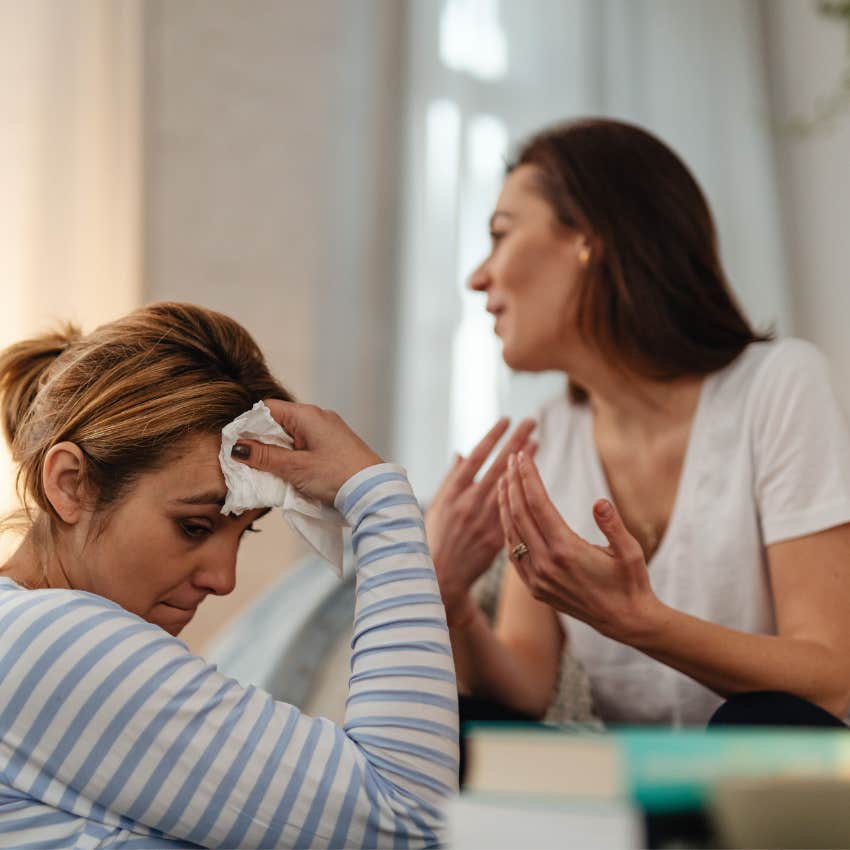 Woman calmly disagreeing with a friend during a serious conversation while the other person looks defensive