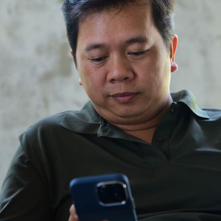 gen X man looking at his phone confused by group chats he's in