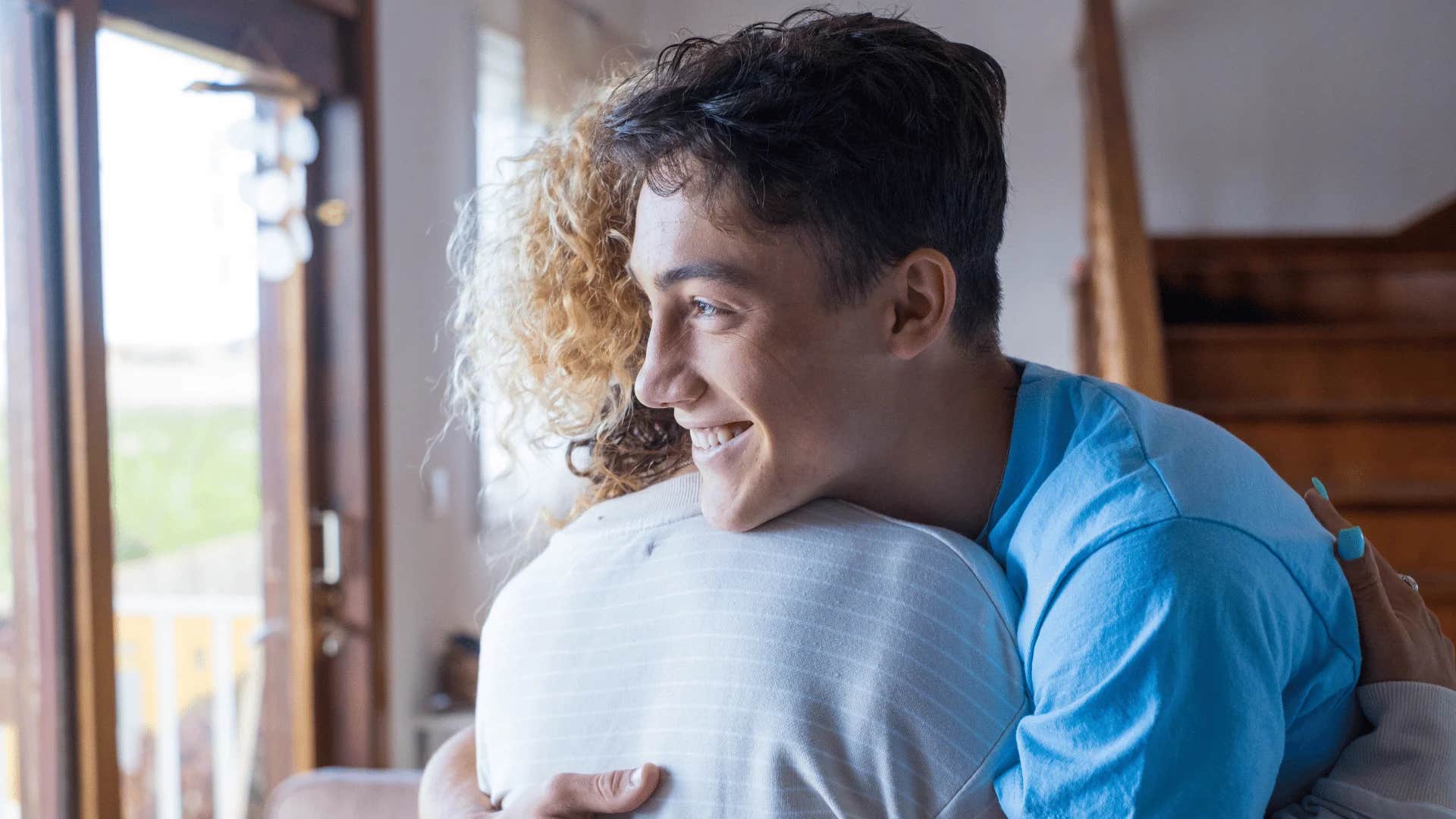 teenager smiling at mom telling telling him not everyone will like you that's okay