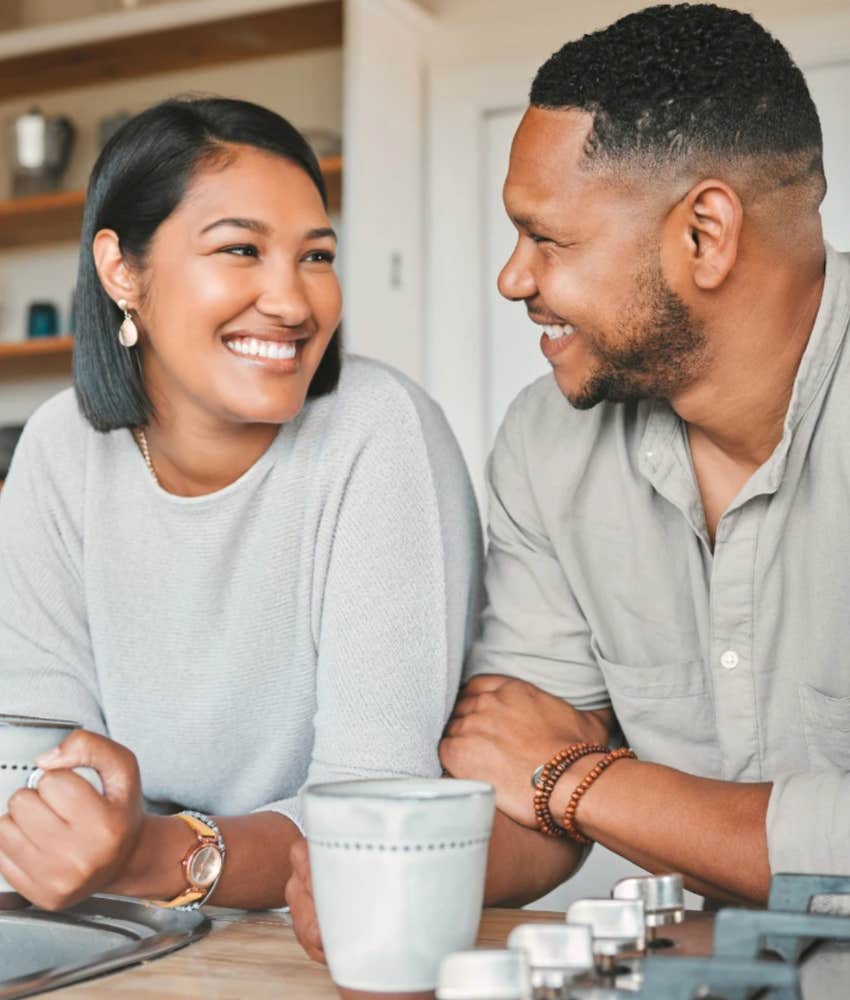 Gen Z couple talking vulnerably over coffee at home 