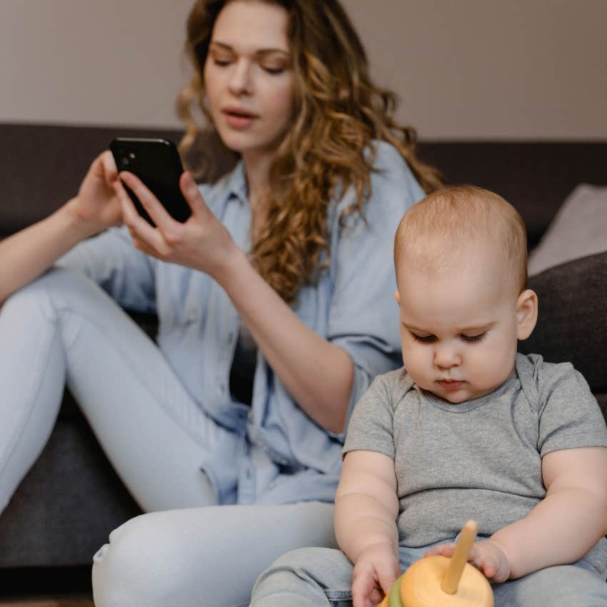 mother ignoring her child distracted by her phone