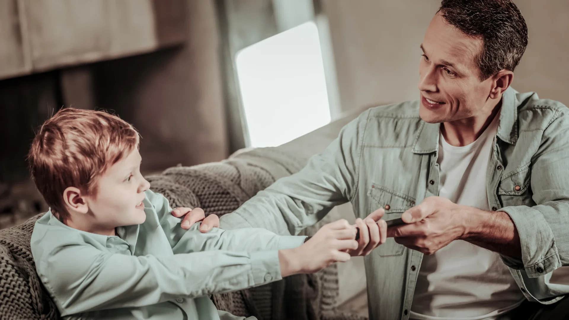 man taking toy away from boy saying i bought it so it belongs to me