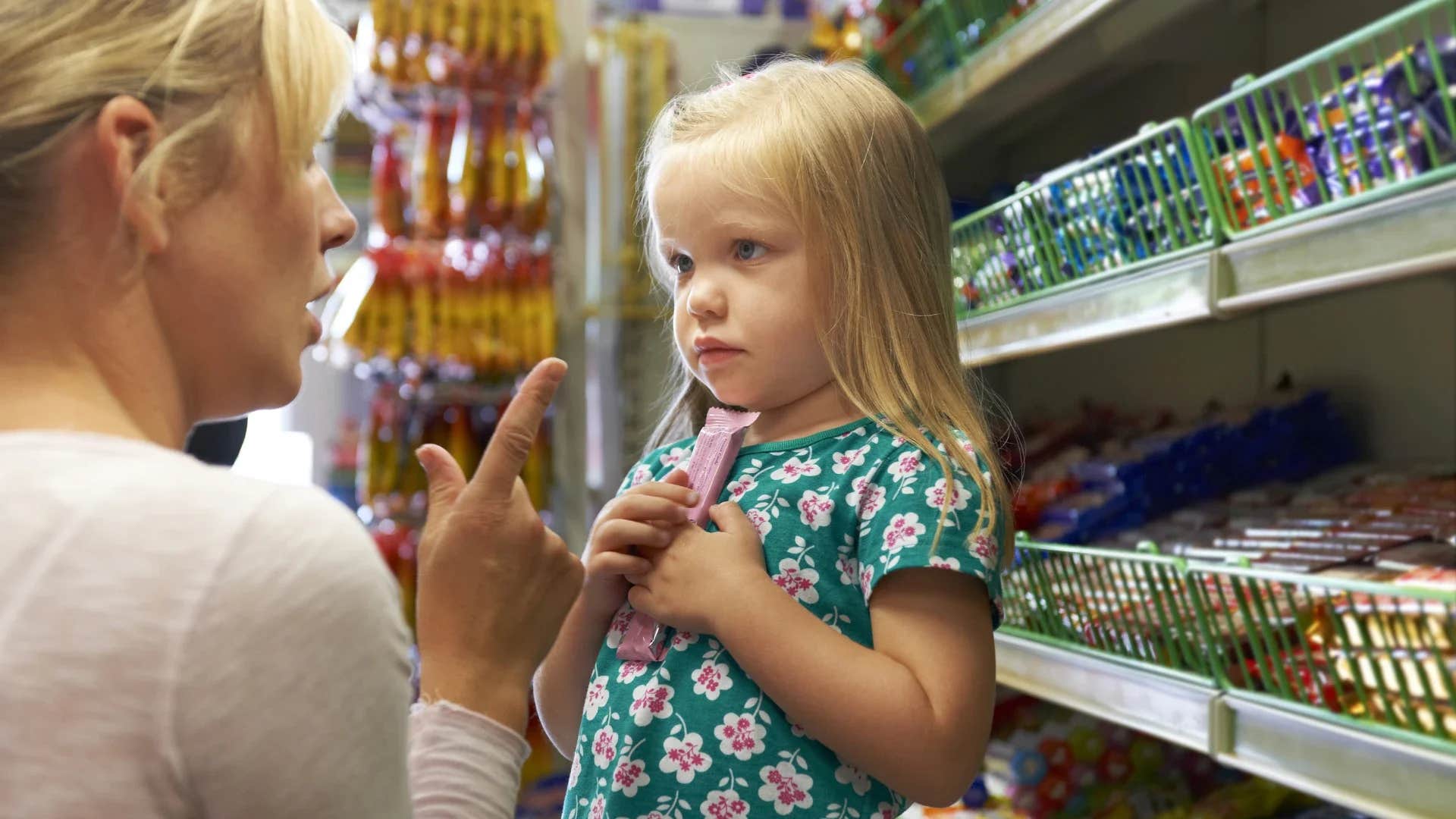 woman scolding young girl saying that's a waste of money