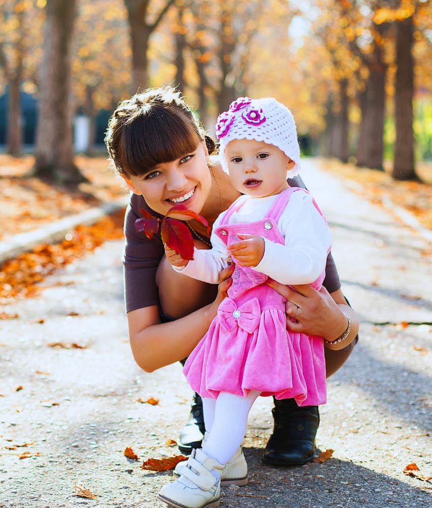 Mom making memories with her little daughter in a fall park