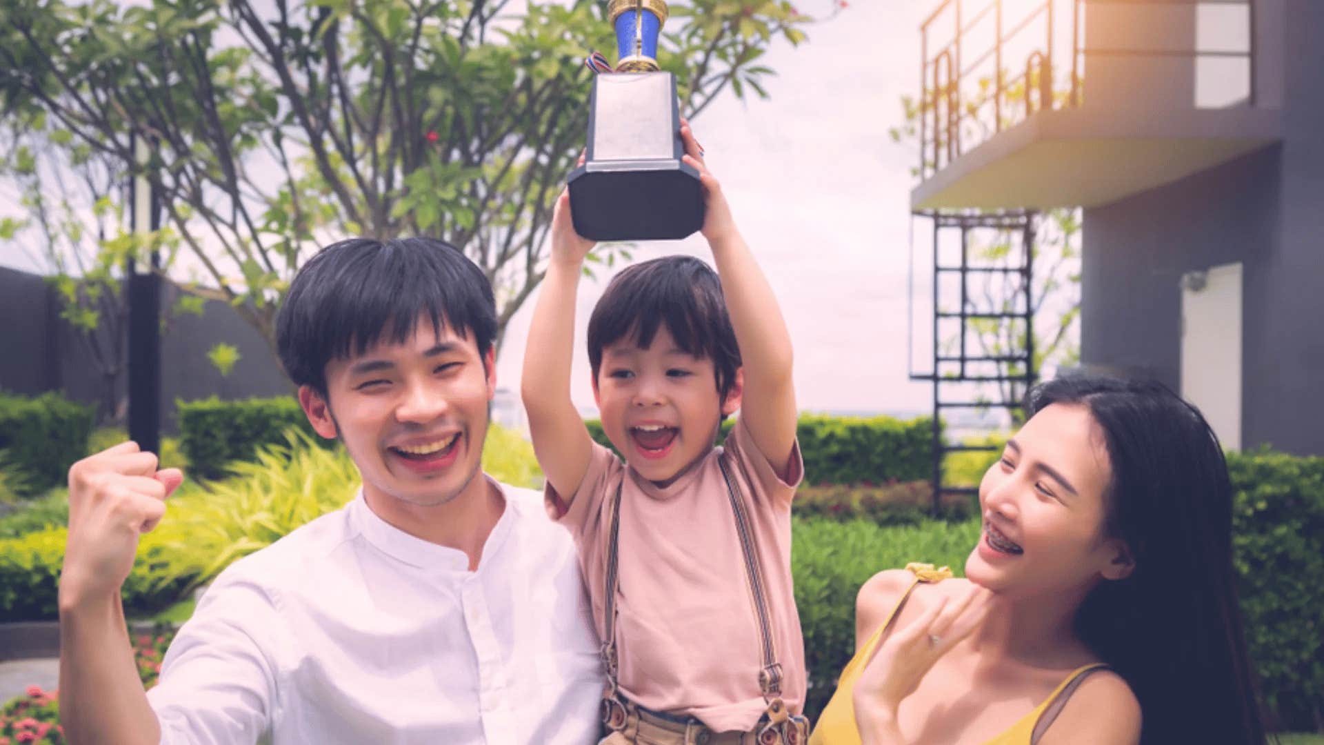 parents feeling proud of their son for winning a trophy