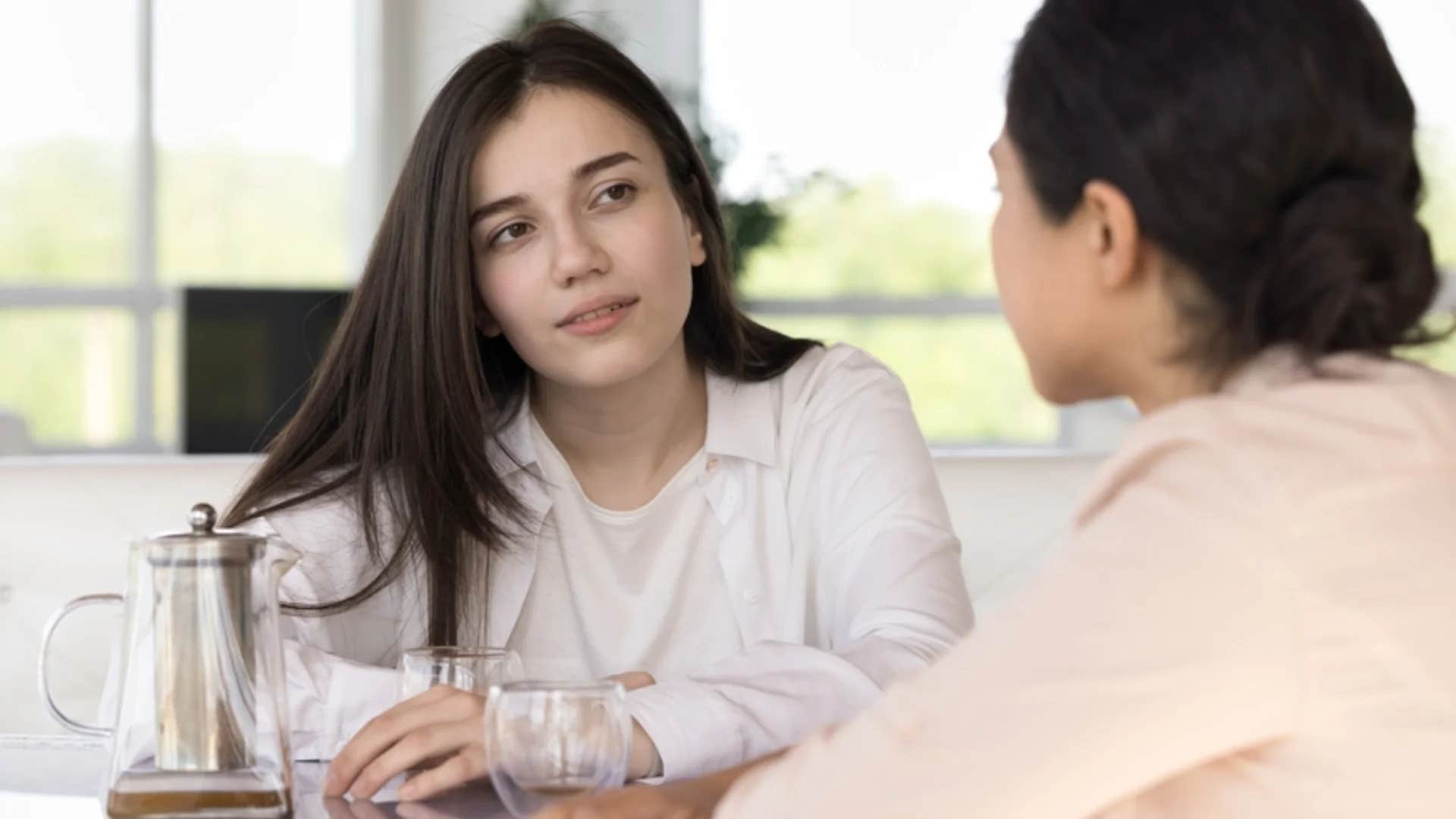woman secretly judging friend saying oh wow
