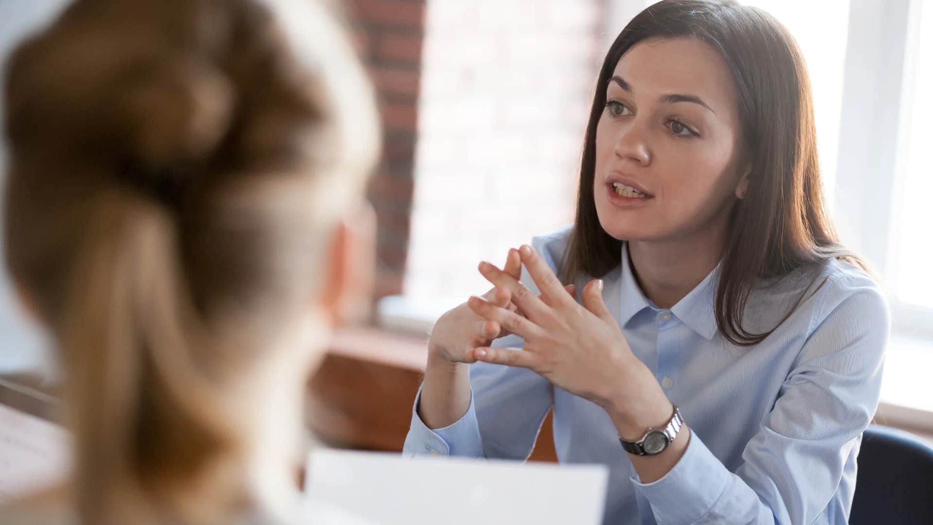 professional woman telling colleagues i hear you but let's be respectful
