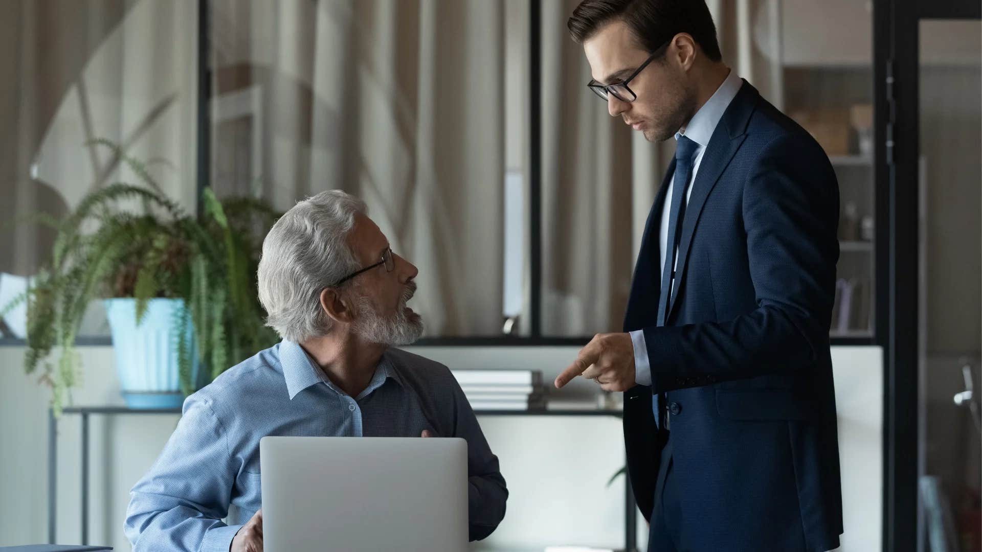 man telling older colleague that he would feel the same in their shoes