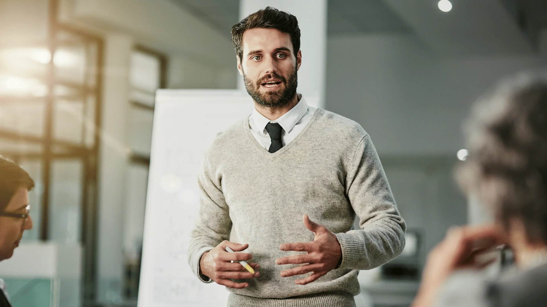 man reassuring group that success is measured by impact not just output