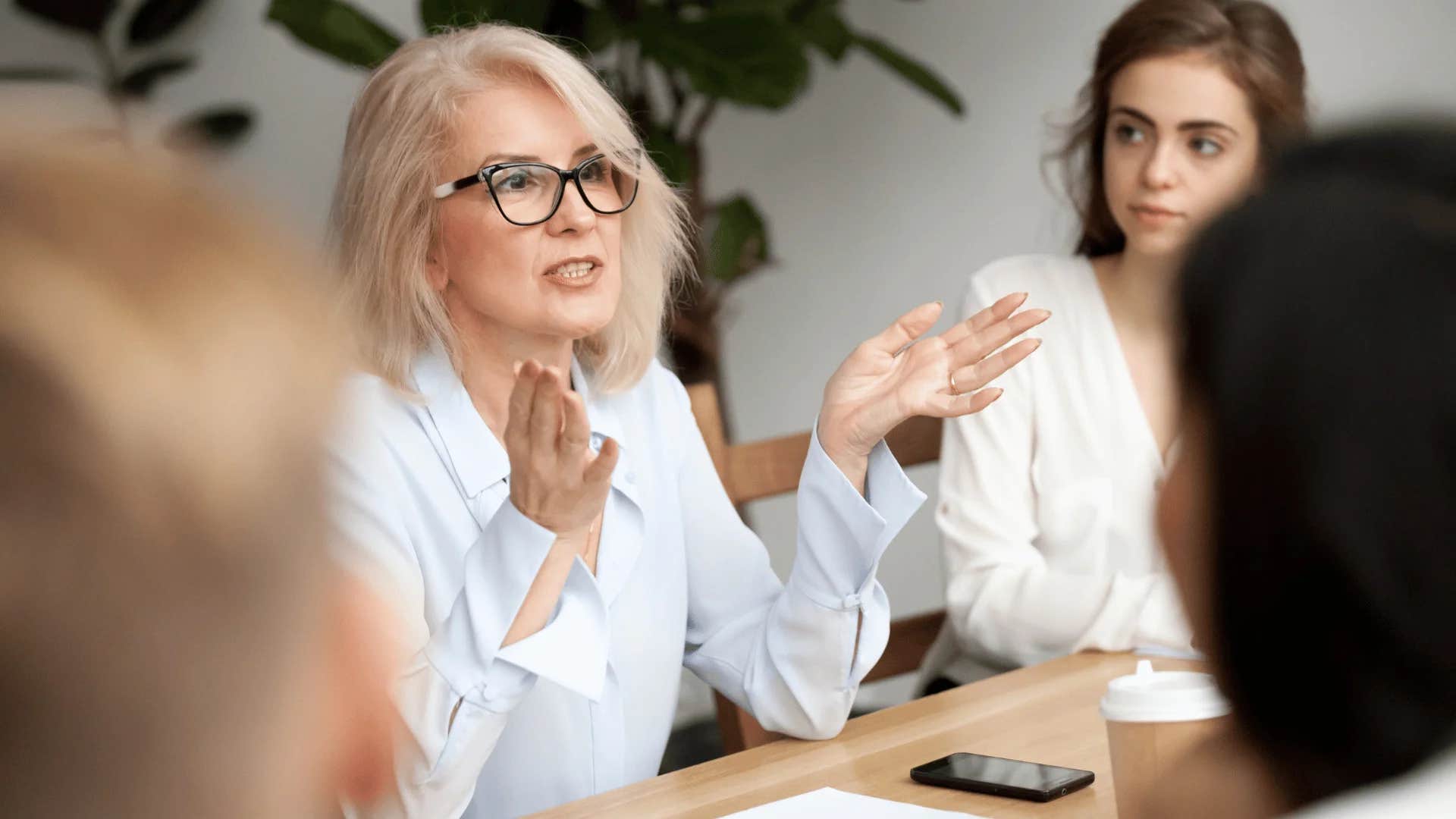 woman speaking to colleagues let's take ownership of this