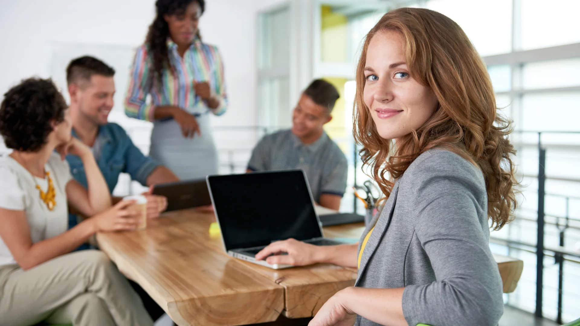 professional woman telling group we need to disrupt the status quo