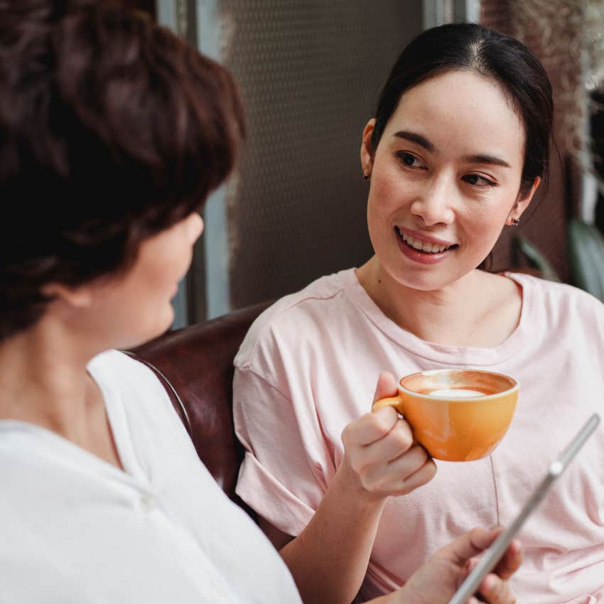 Calm woman listening to a friend during a conversation without reacting defensively