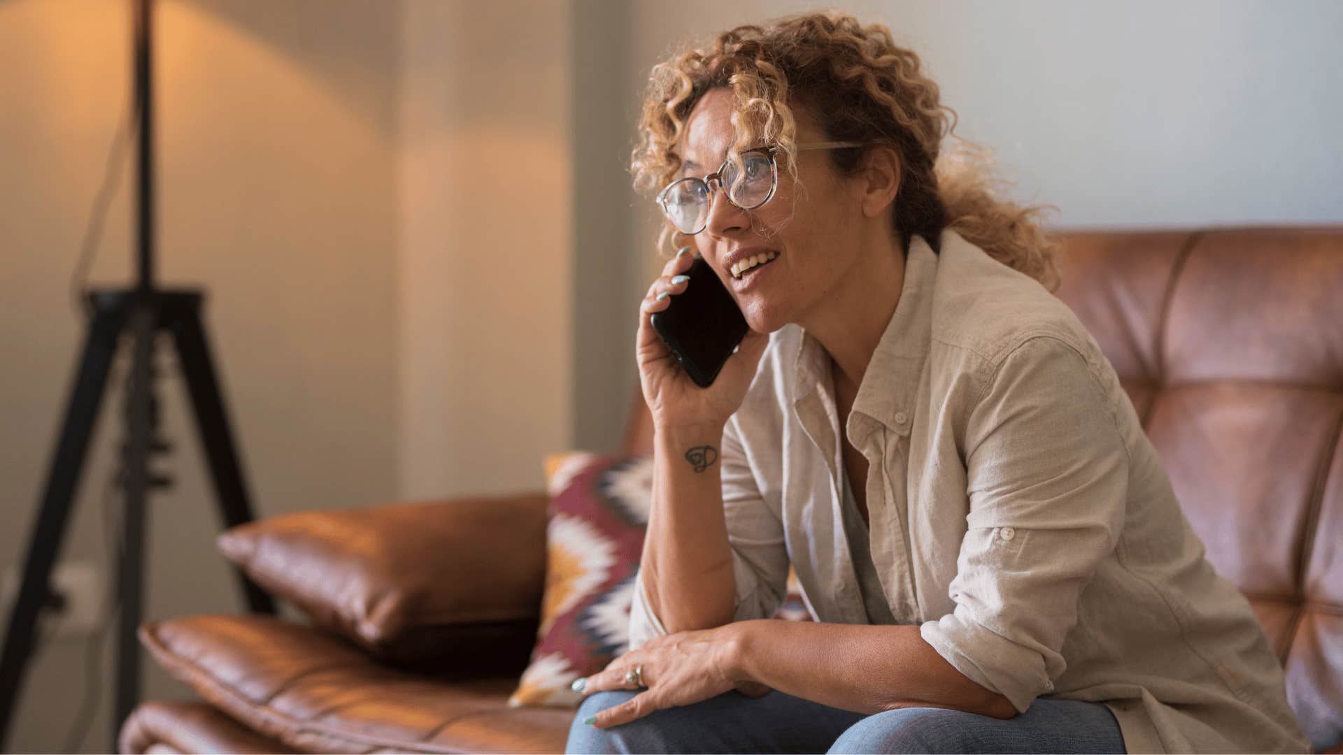 woman on phone saying i wasn't expecting anyone as she looks slightly panicked