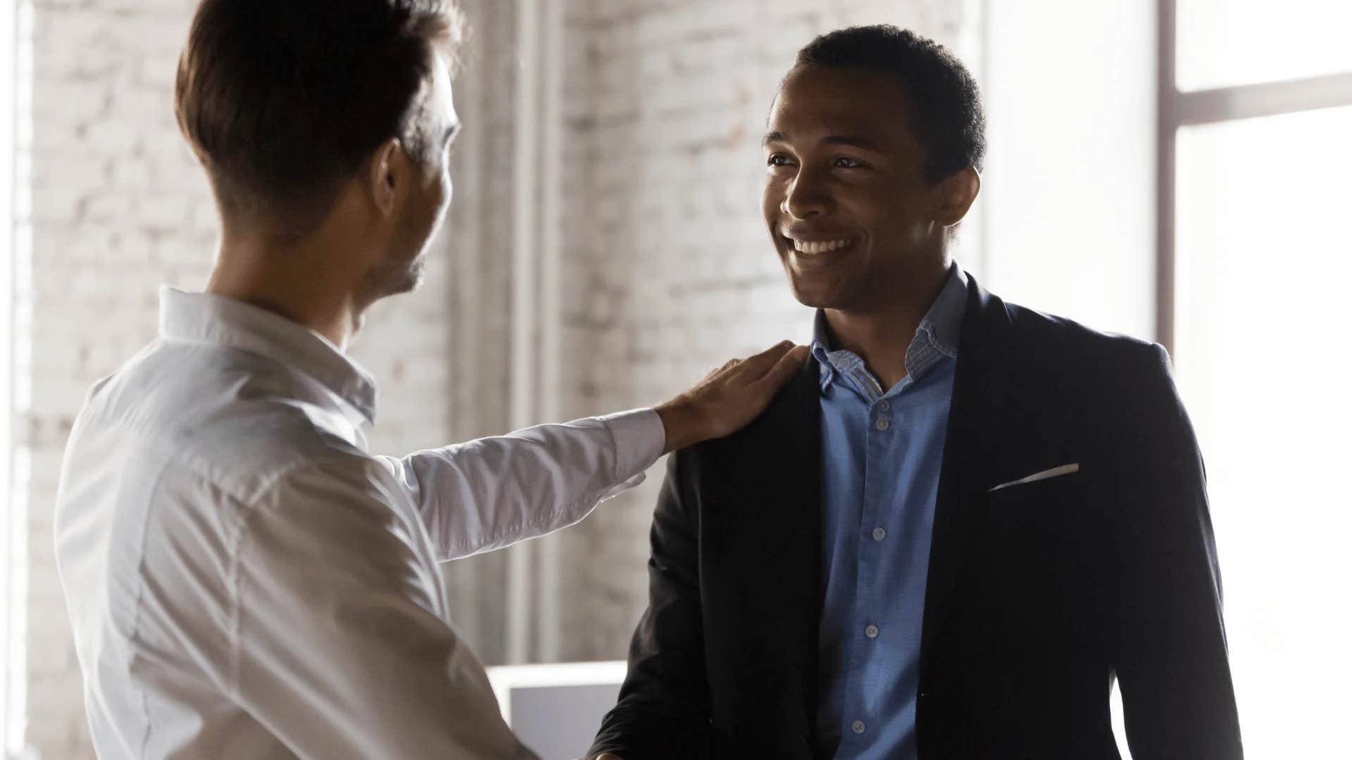 man reassuring colleague it's not worth the energy