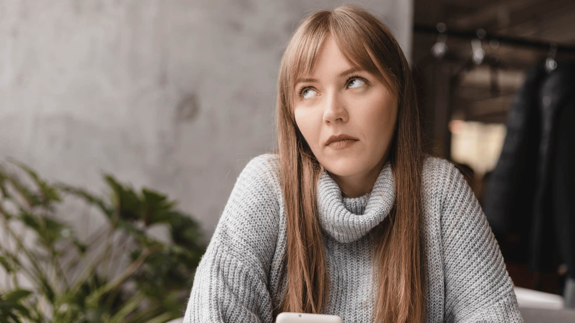woman in gray sweater rolling eyes as she says i don't really care anymore