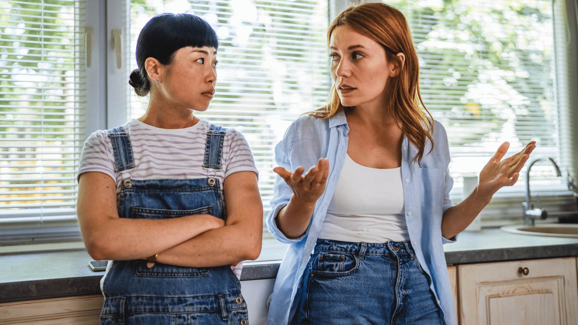 woman with blonde hair telling friend i have enough going on already