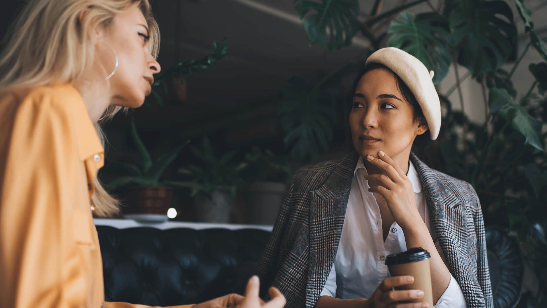 friend in white shirt listening to woman in yellow as she says i'm just letting people do their own thing
