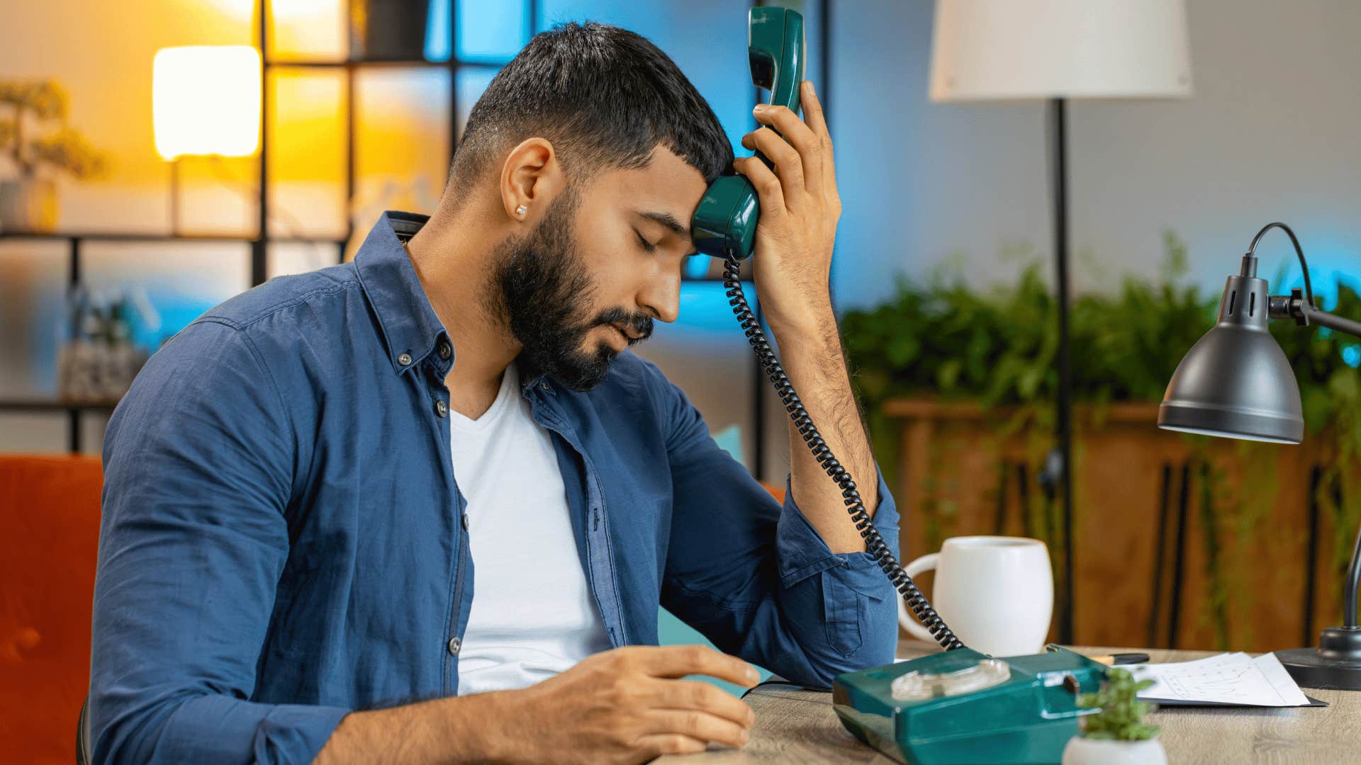 man in white shirt on the phone frustrated as he thinks i'm too old for this