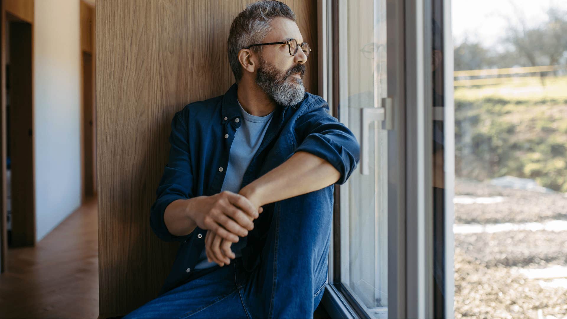 man staring out the window getting time to himself