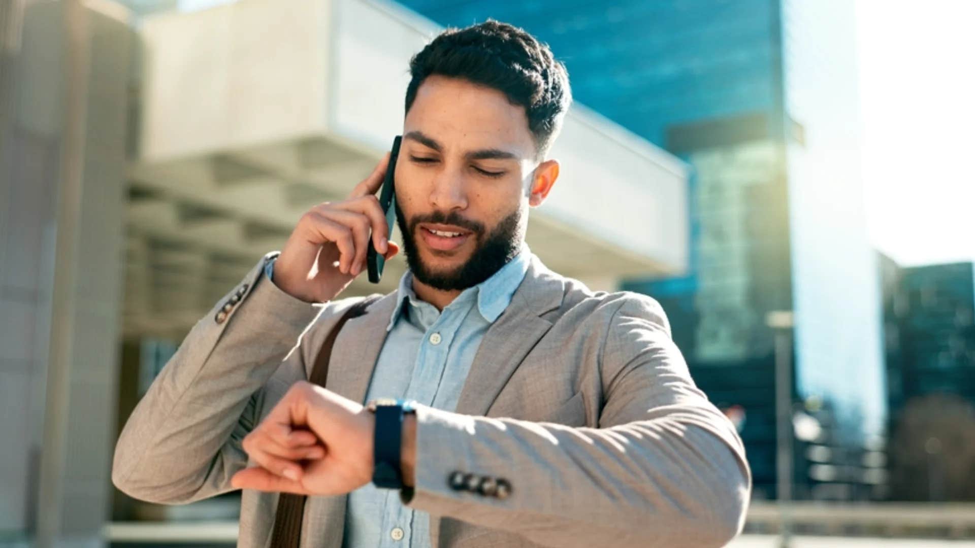 man looking down at wrist time being his most valuable asset