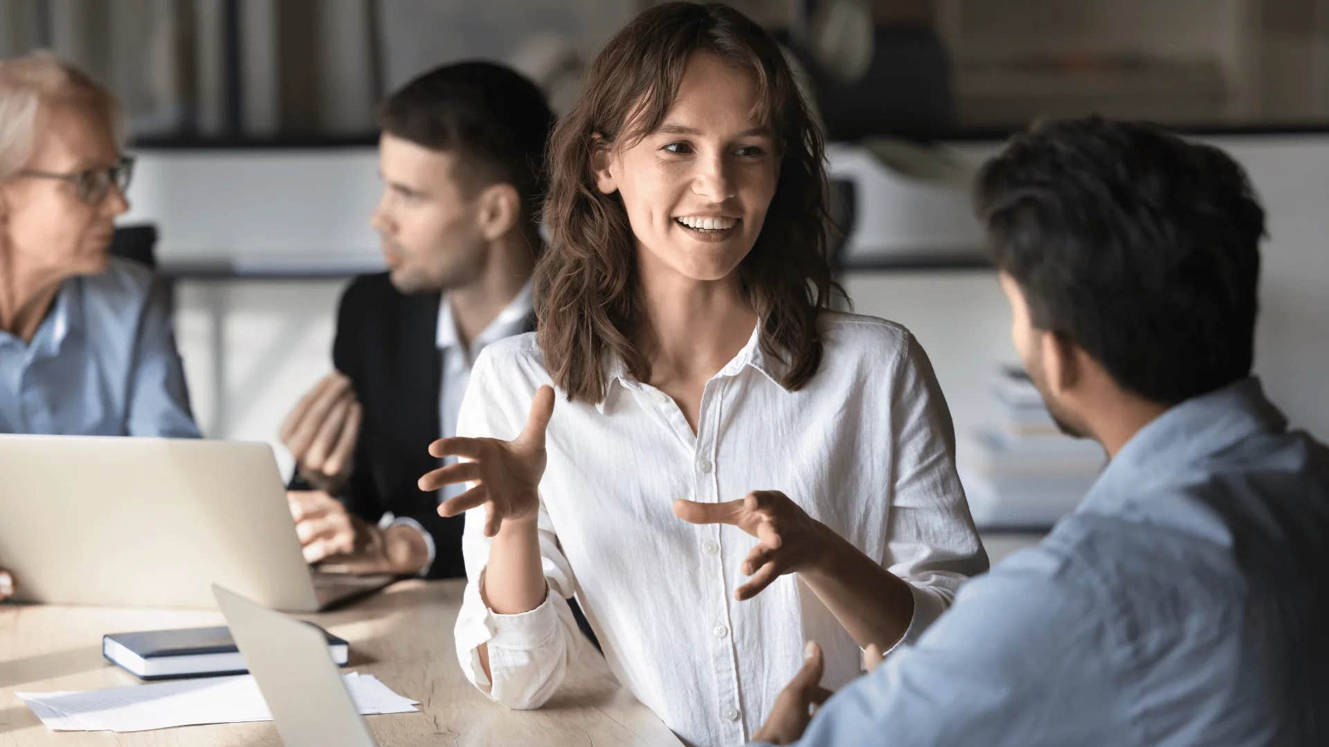 woman telling colleague i think you should consult this person on this matter