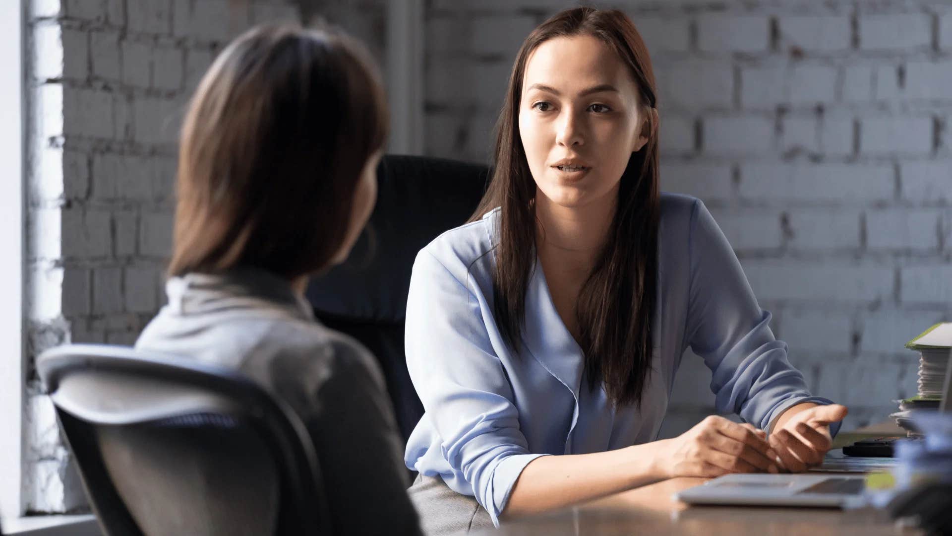woman telling colleague i wish i could help but i'm not qualified