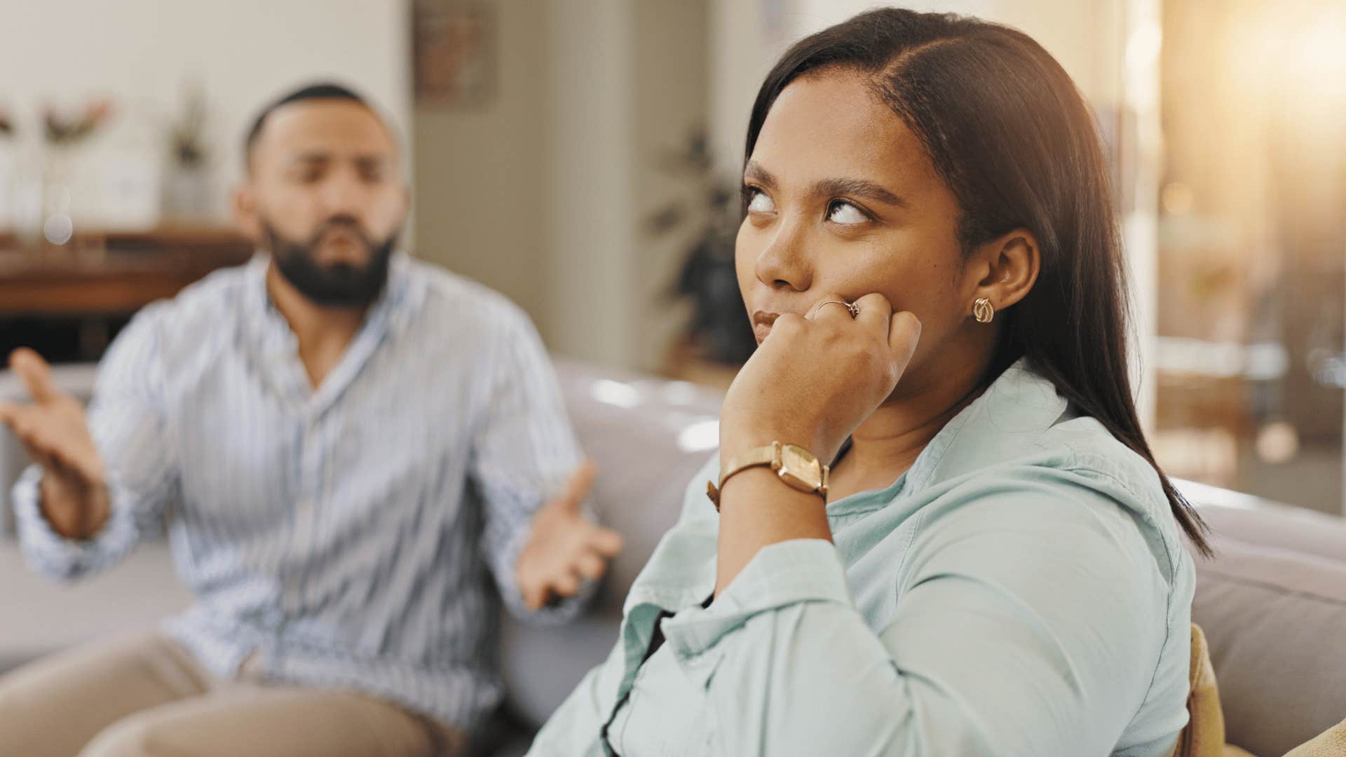 woman rolling eyes at man as she thinks did i ask