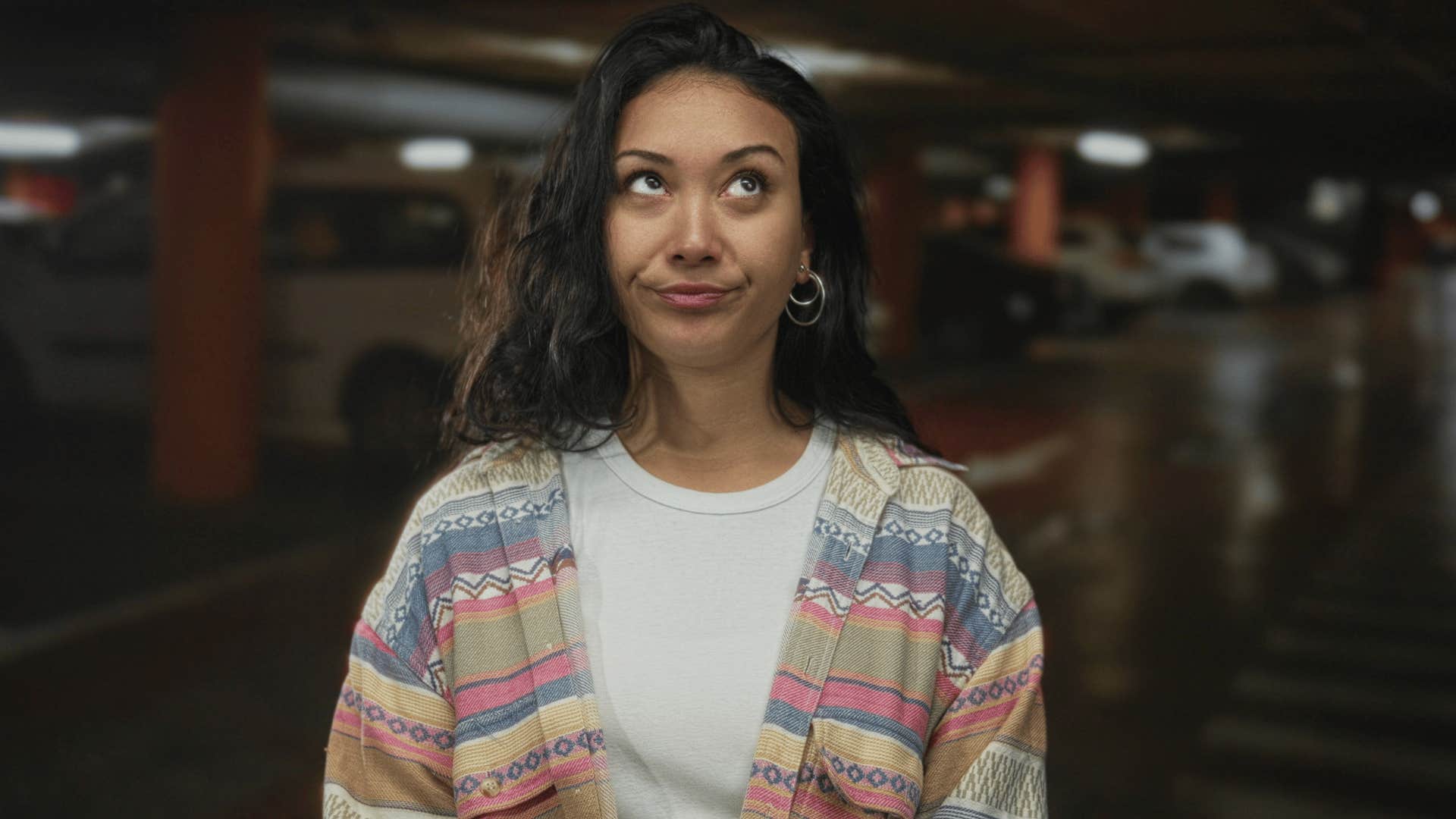 woman in white shirt rolling eyes as she thinks must be nice