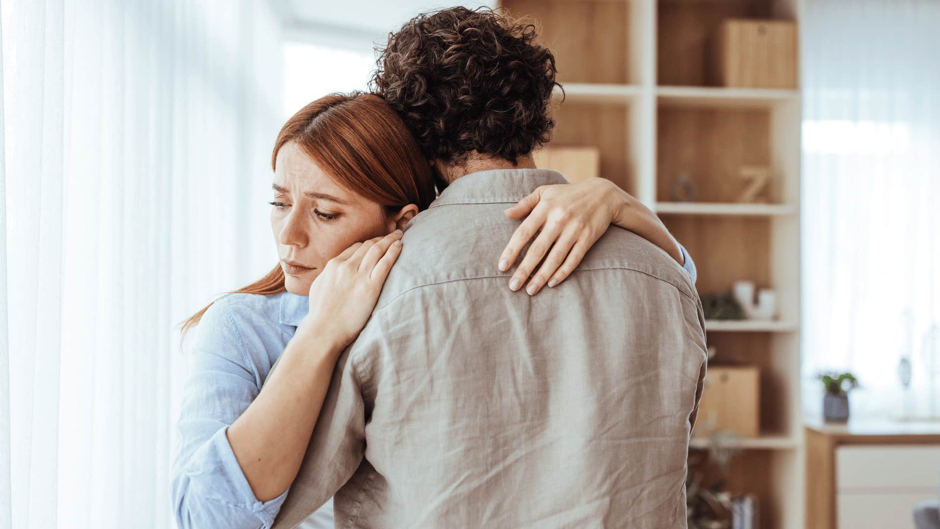 woman in blue shirt hugging man as man tells her let's not overthink it