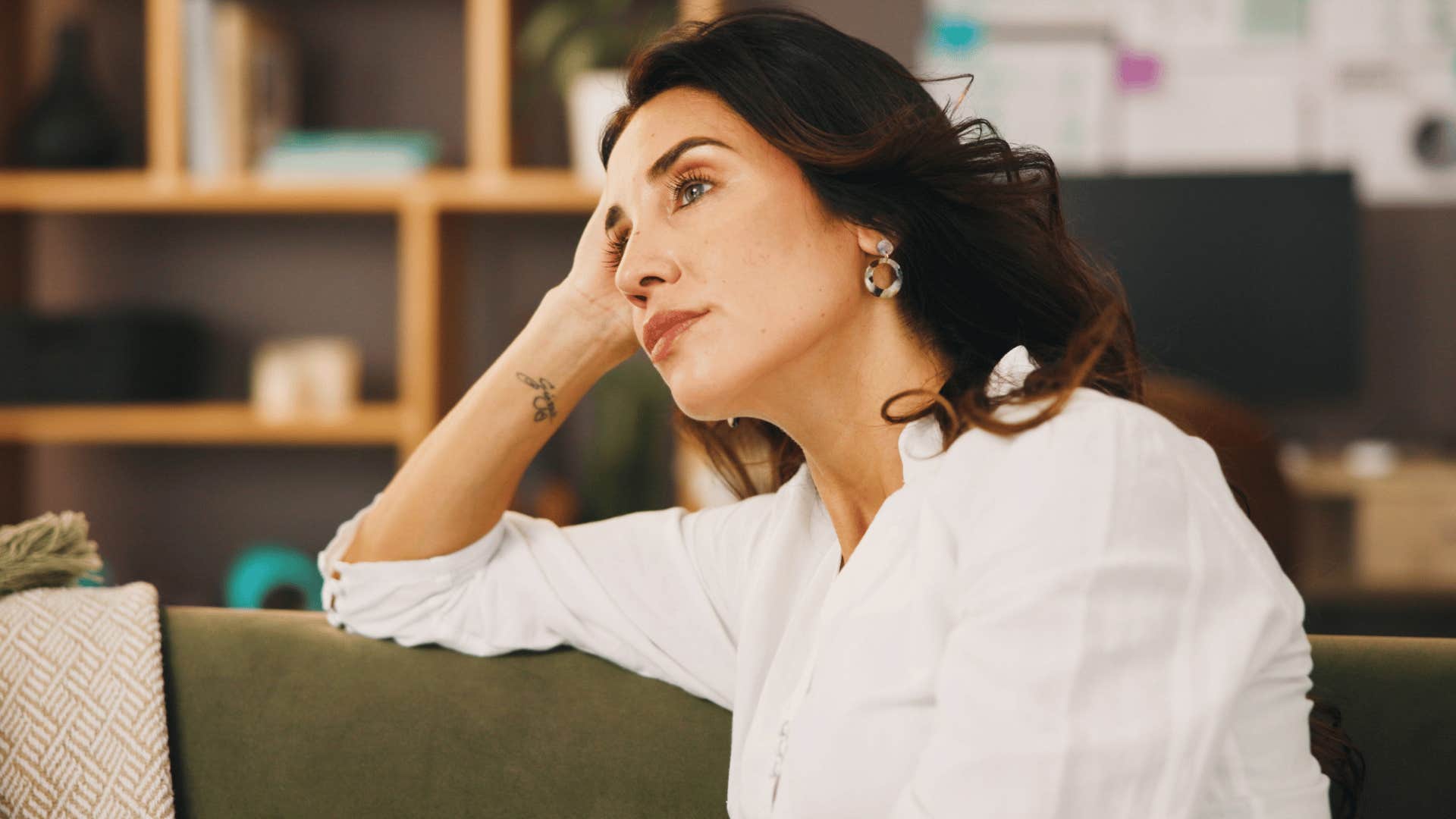 woman in white shirt on the couch thinking deeply about how people change
