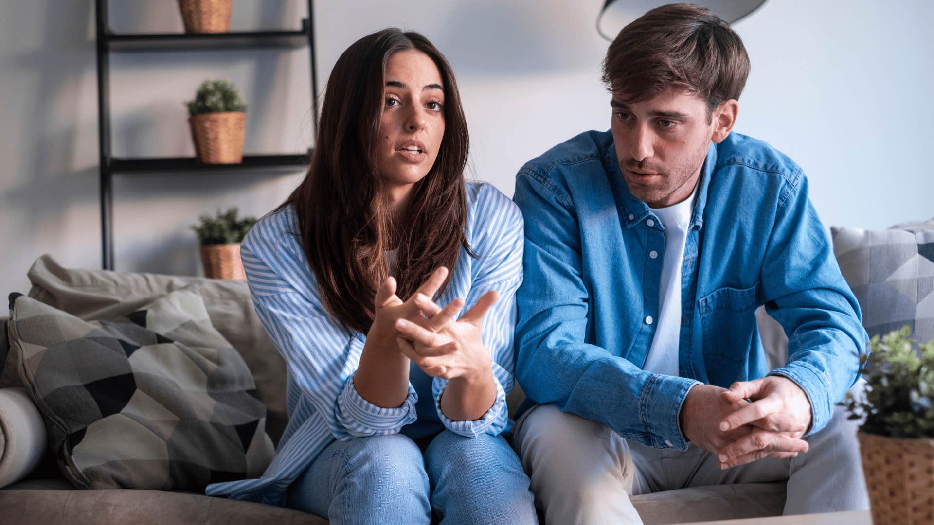 woman admitting to man i messed up as they talk on couch