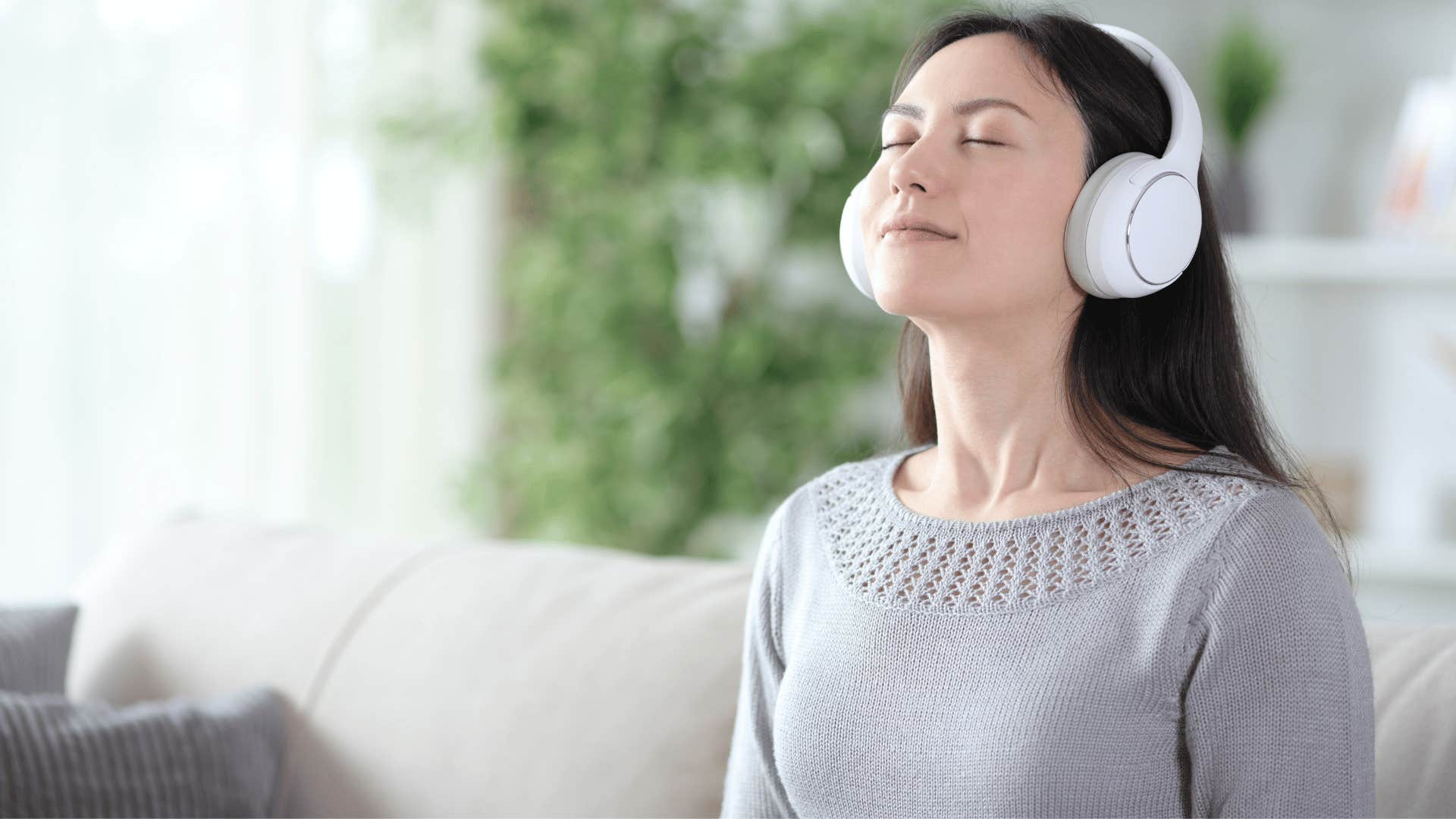 woman in gray sweater meditating as she thinks one step at a time