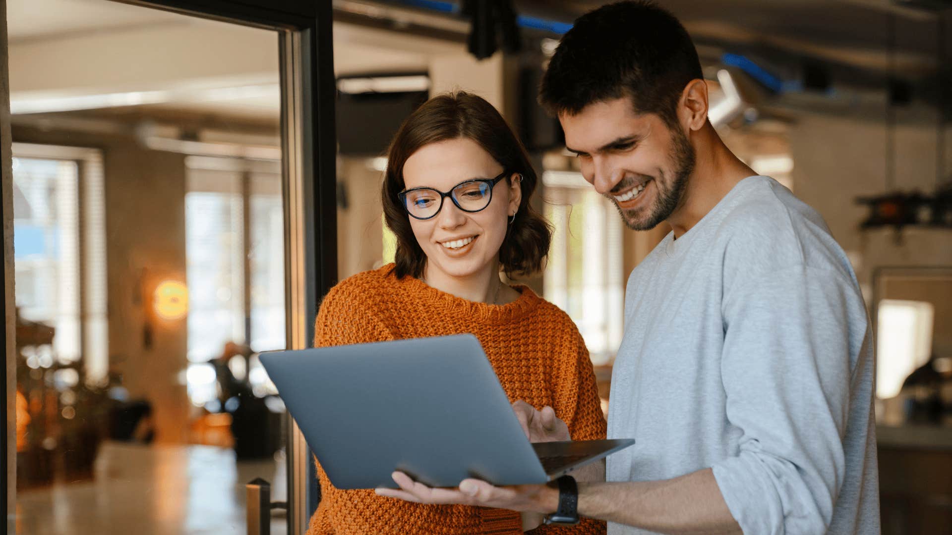 woman with orange shirt helping coworker as she thinks they'd be lost without me