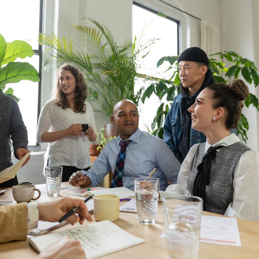 Employee enthusiastically agreeing with a manager during a workplace discussion while coworkers listen