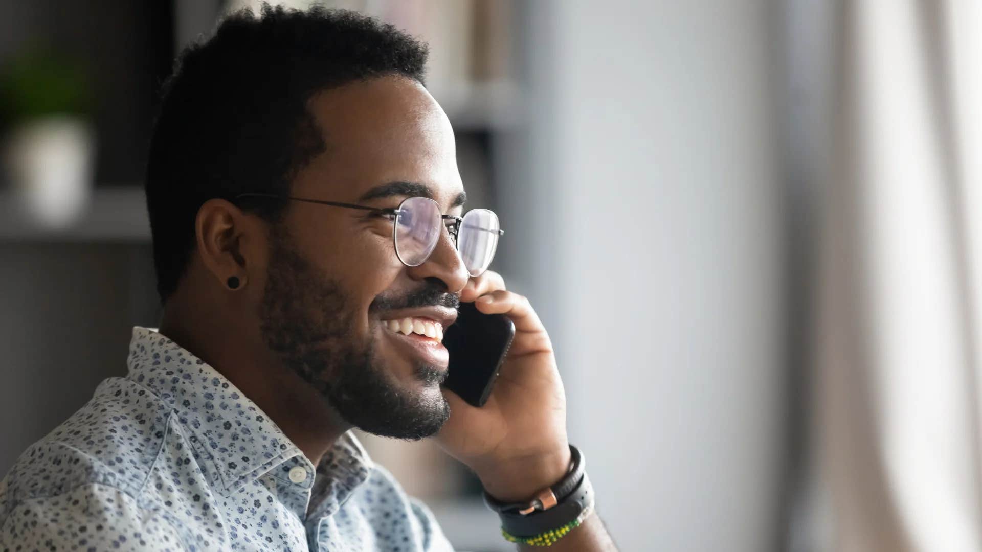 man on phone saying tell me more
