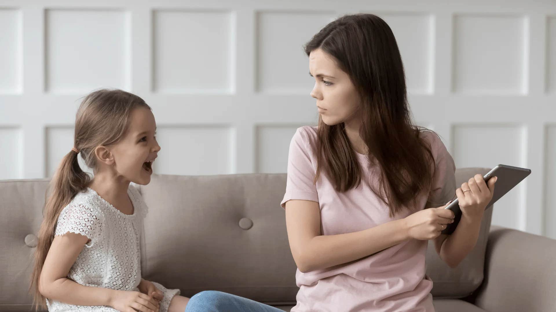 woman telling young girl if you don't stop crying i'll give you something to cry about