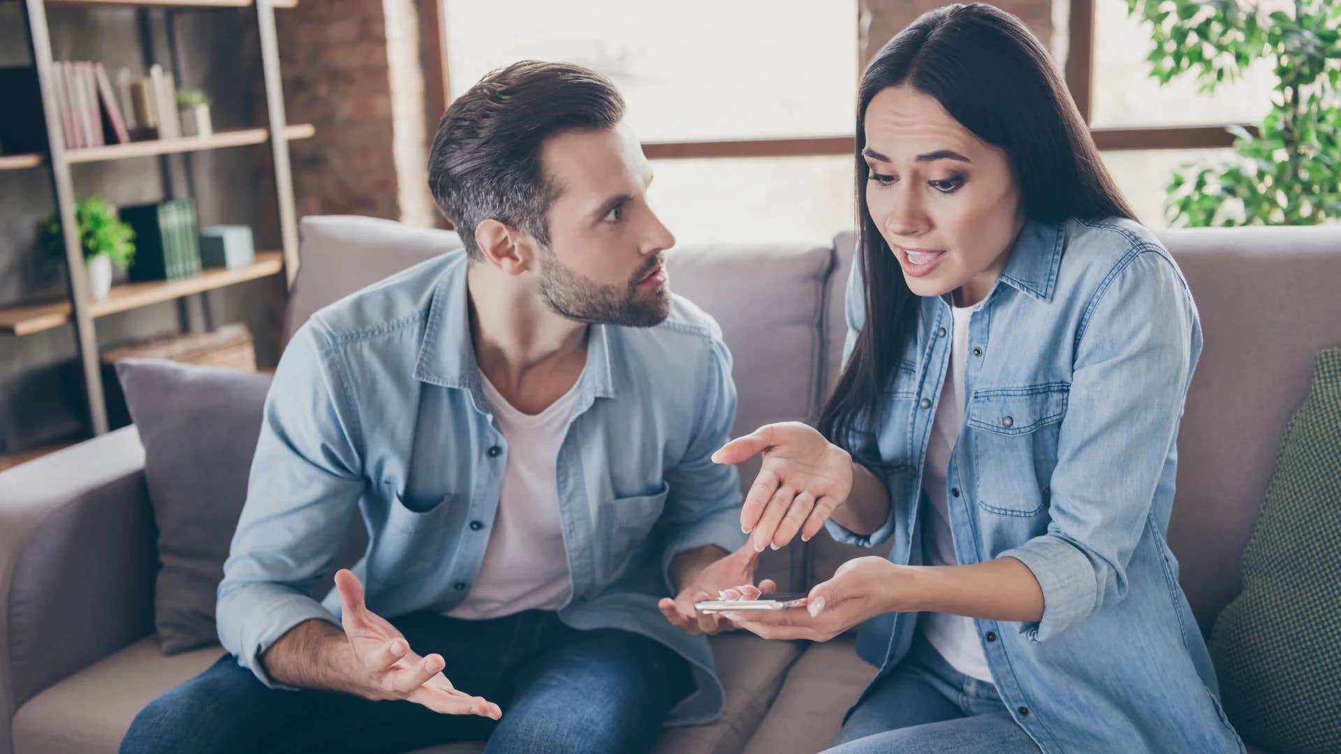 man telling upset woman to calm down